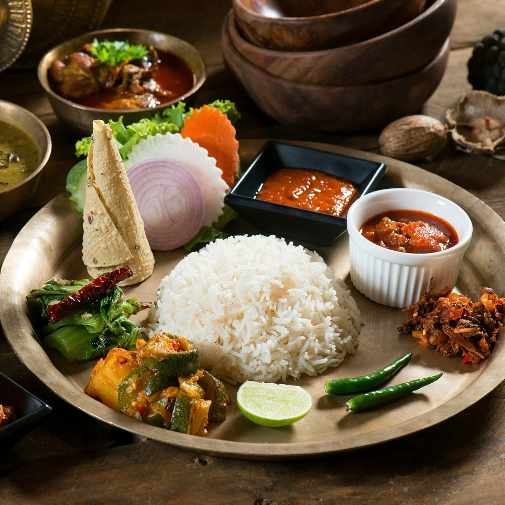 Authentic Nepali thali with rice, vegetables, and curries.