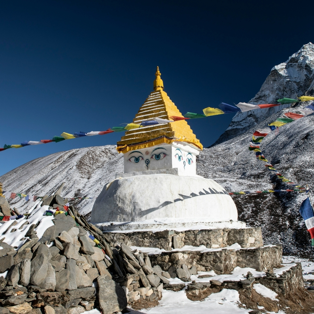 Stupa with prayer flags on Himalayan mountain summit, Nepal.