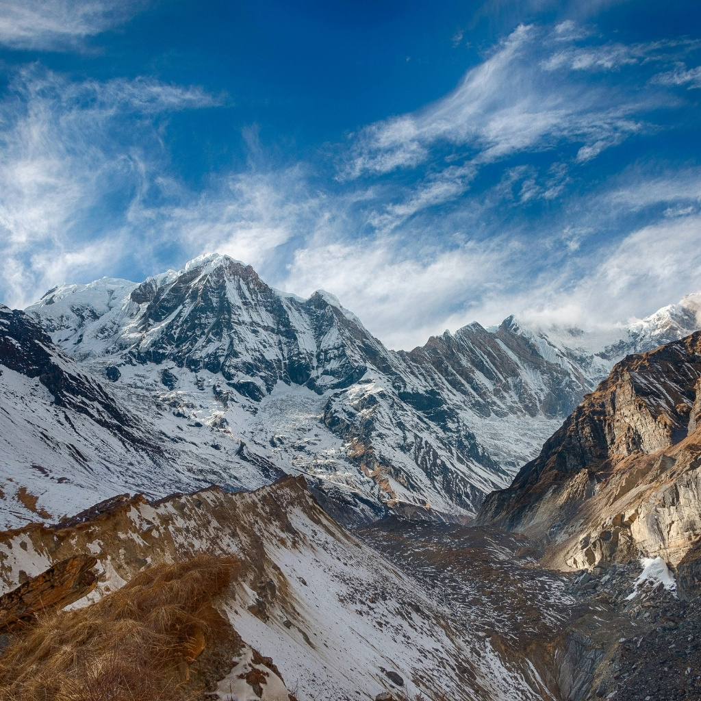 Snow-capped Himalayan mountains under a clear blue sky in Nepal.