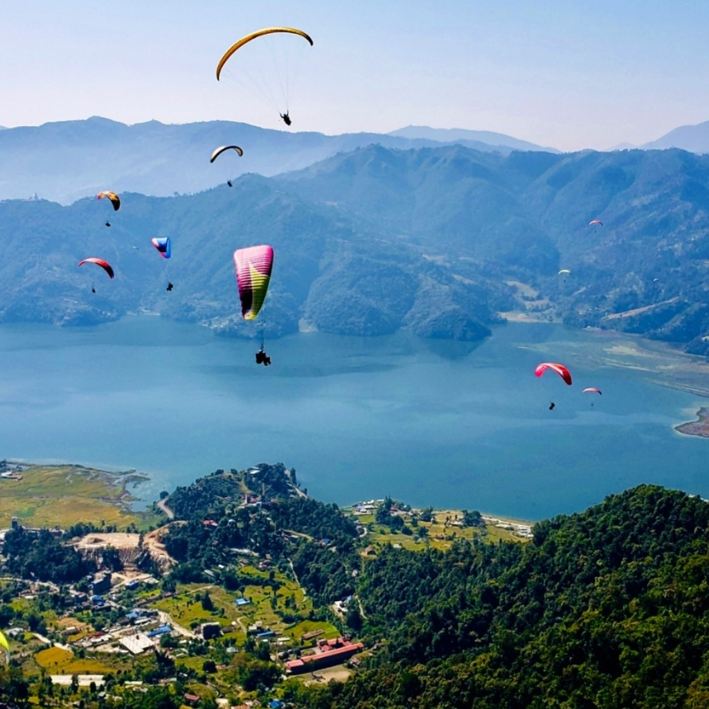 Paragliding adventure over Pokhara's scenic lake and mountains.