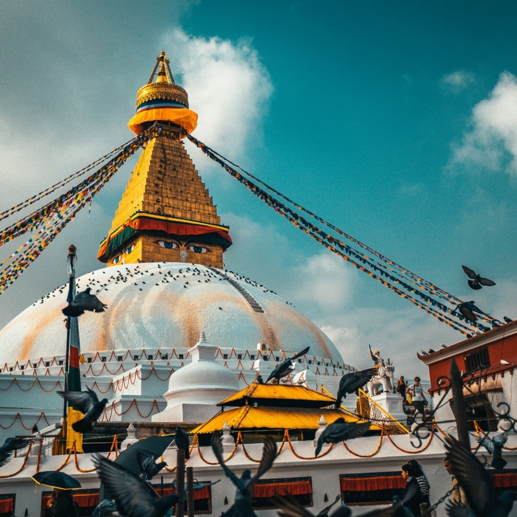 Swayambhunath Stupa with prayer flags and pigeons in Kathmandu, Nepal.